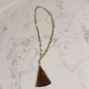 Off white shell and bead necklace with tan tassel; 20 in long